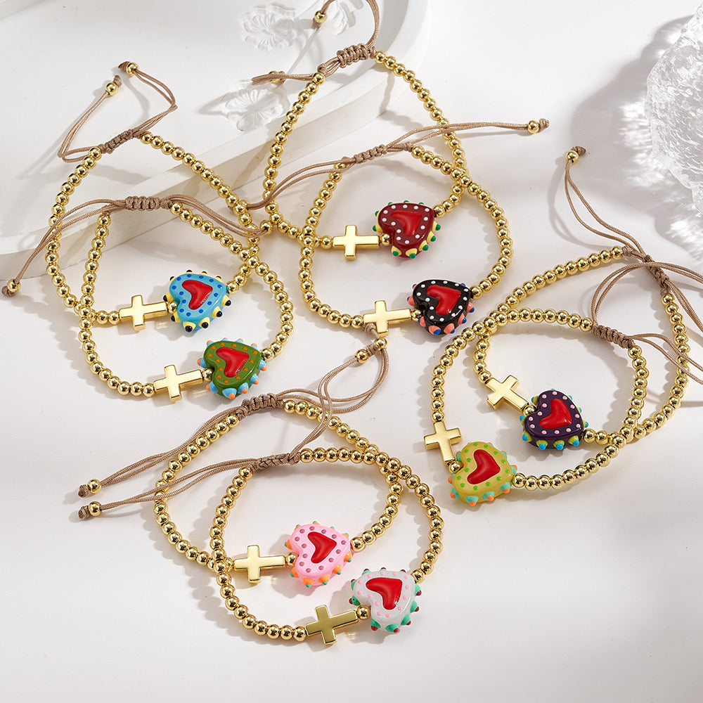 Adjustable bracelet with gold beads, cross and heart, enamelled blue with red