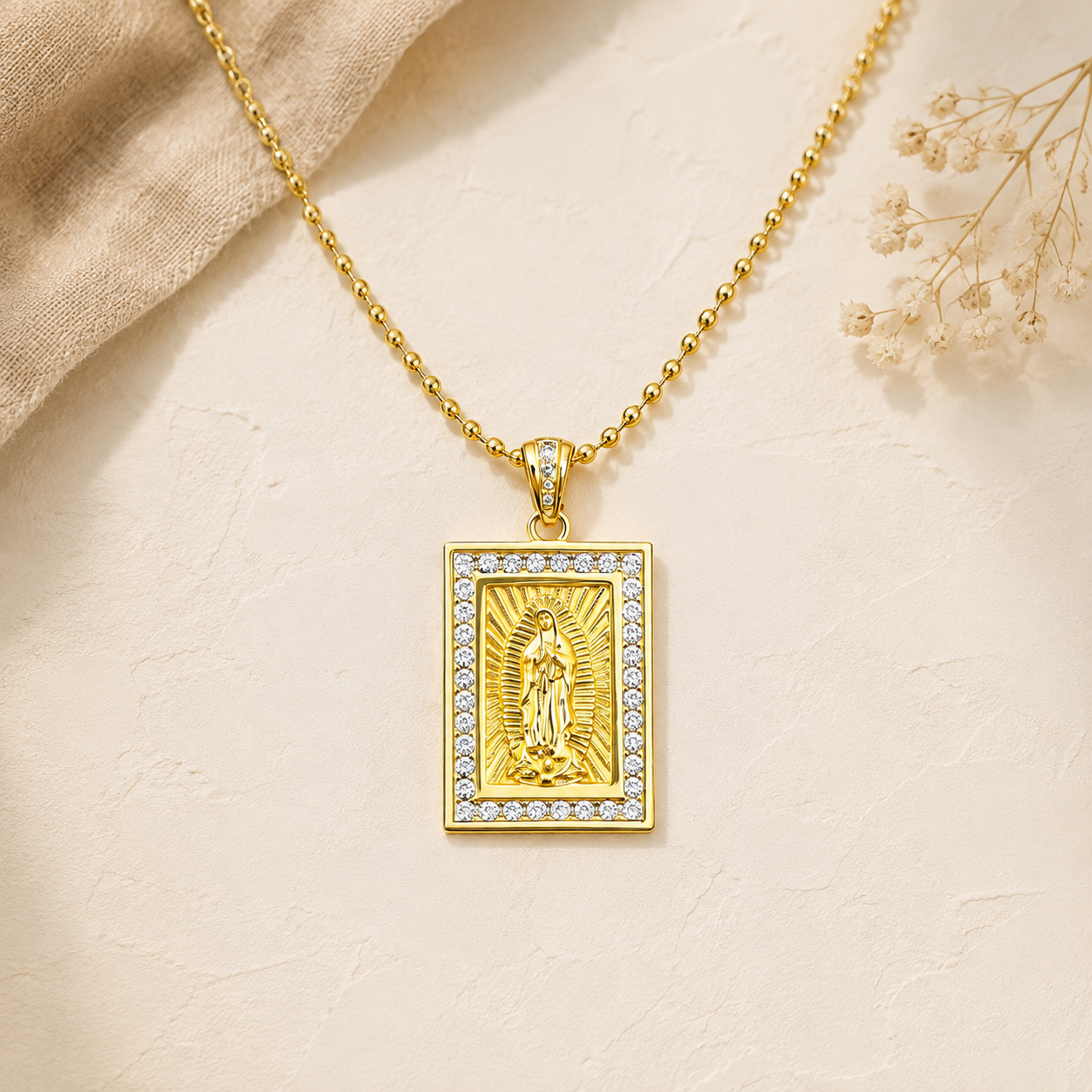 Gold necklace with a sparkly Virgin of Guadalupe medal