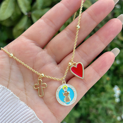 Trendy gold necklace with Saint Francis, cross and red heart
