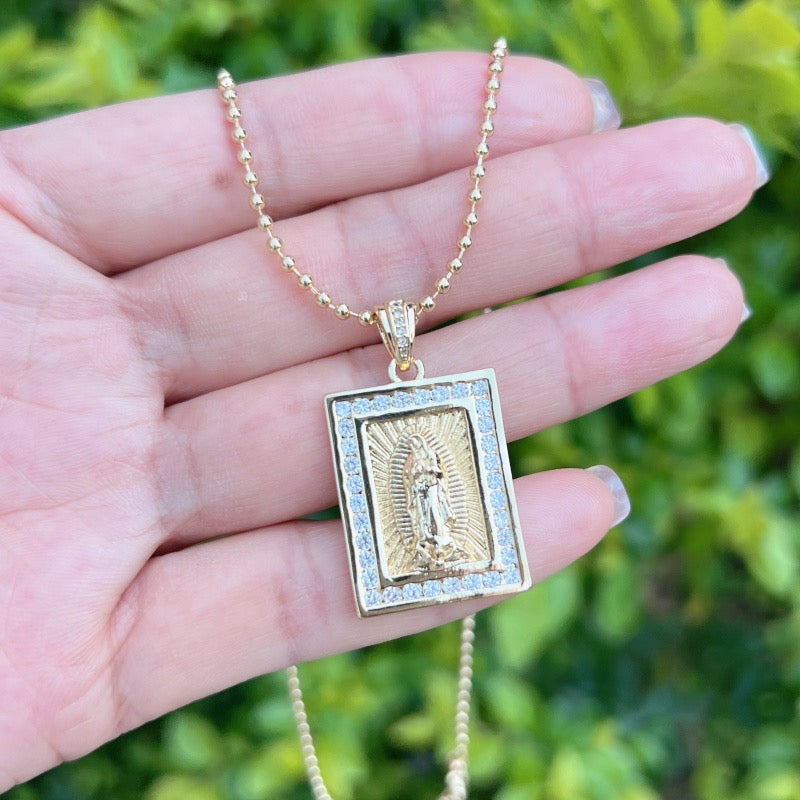 Gold necklace with a sparkly Virgin of Guadalupe medal