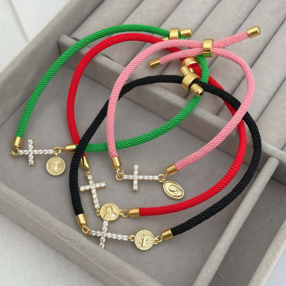 Black bracelet with a zirconia cross and a religious charm of Saint Benedict the Abbot