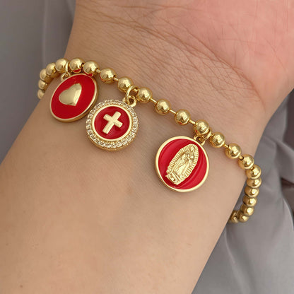 Red woven bracelet with gold pavé charm