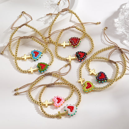 Adjustable bracelet with gold beads, cross and heart, enameled green with red