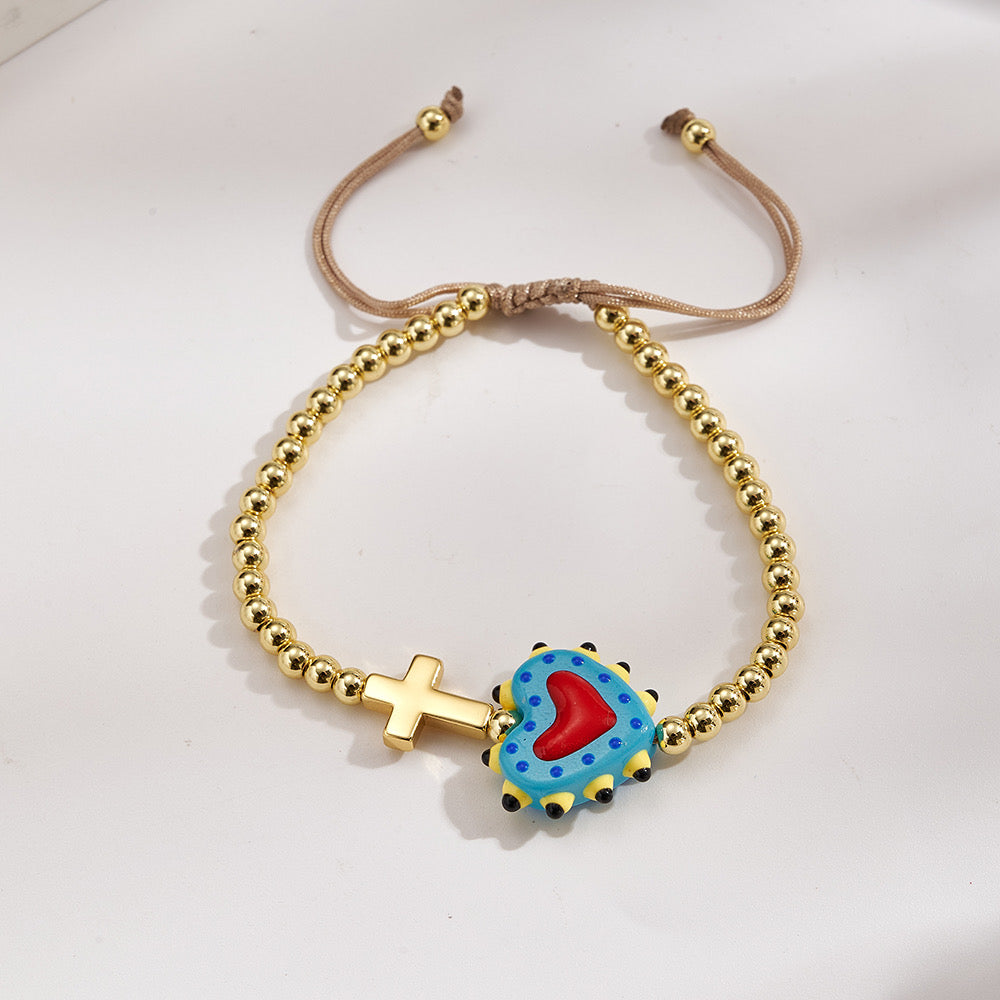 Adjustable bracelet with gold beads, cross and heart, enamelled blue with red
