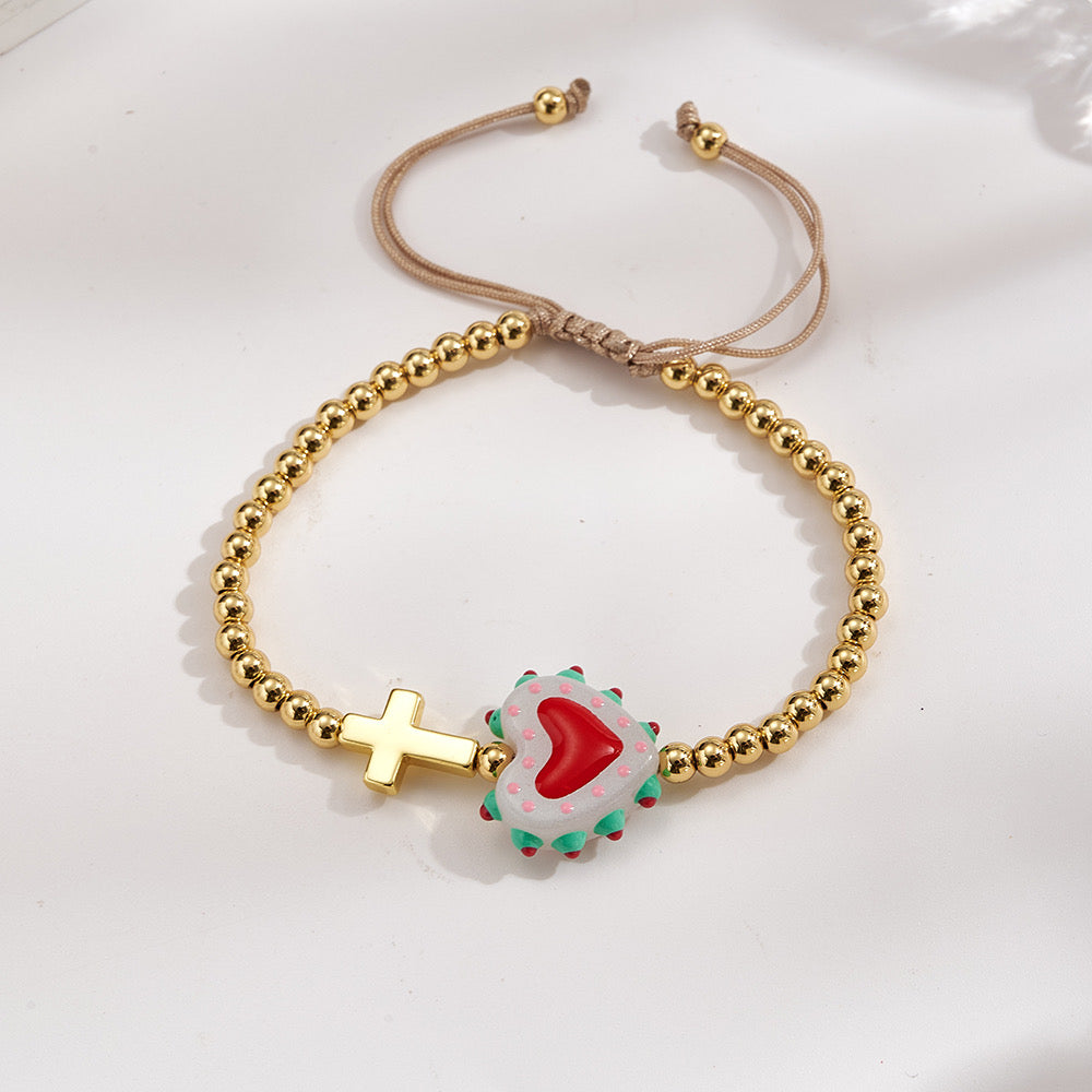 Adjustable bracelet with gold beads, cross and heart, enameled white with red
