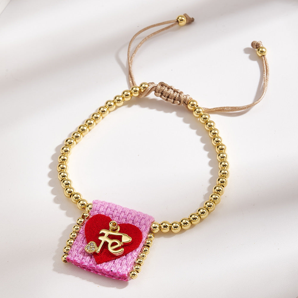 Brazalete ajustable con cuentas doradas y corazón Fe rosa