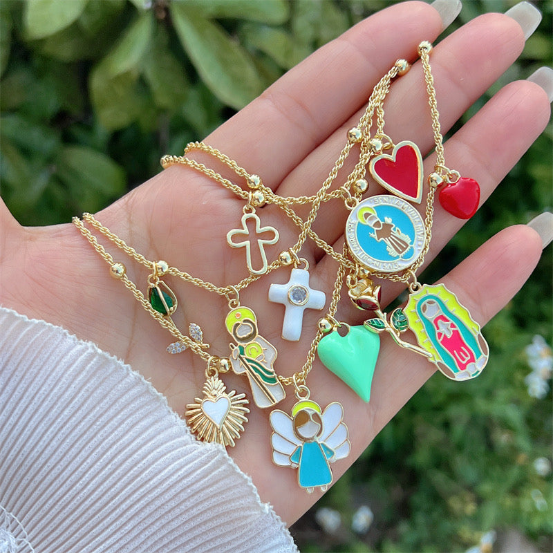 Trendy gold necklace with angel, green heart and sacred heart