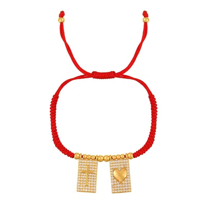 Brazalete rojo ajustable con cruz y corazón dorados